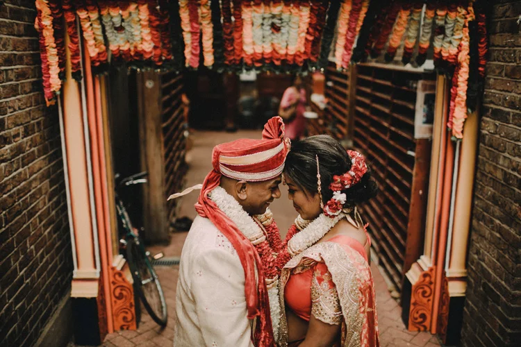 couple share moment after hindu ceremony in temple