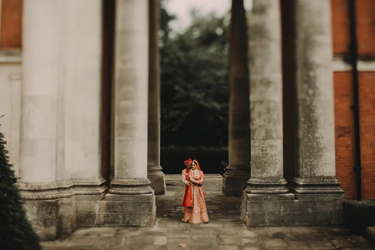 indian couple hold each other after hindu ceremony