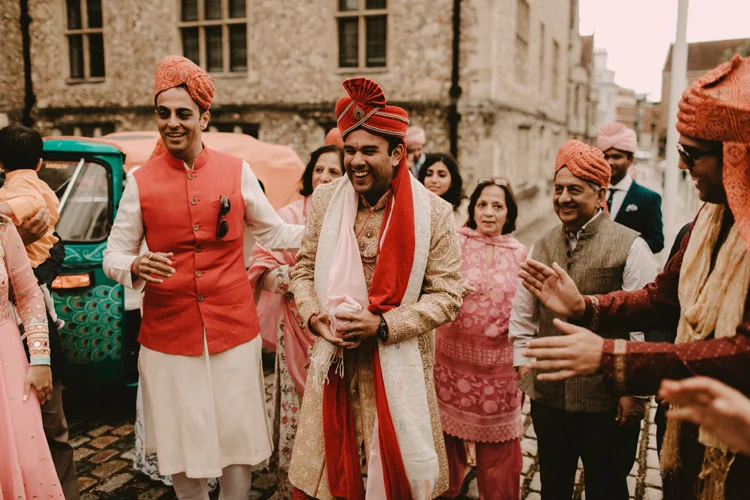 indian groom parading with family before hindu ceremony
