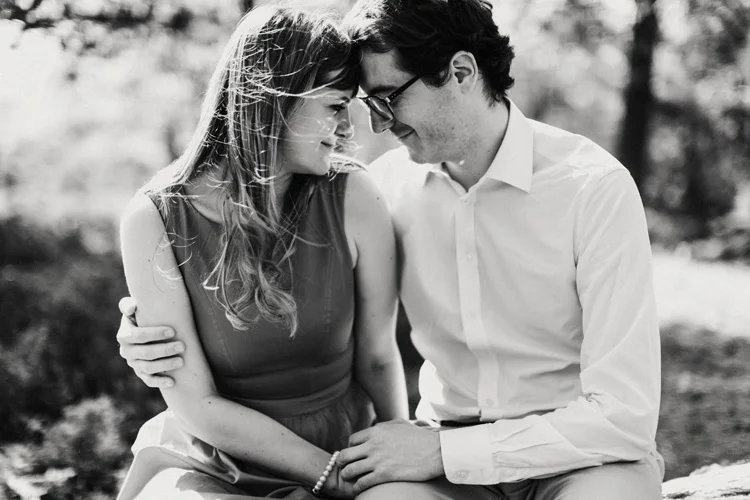 french and russian couple touch foreheads in intimate moment in london engagement