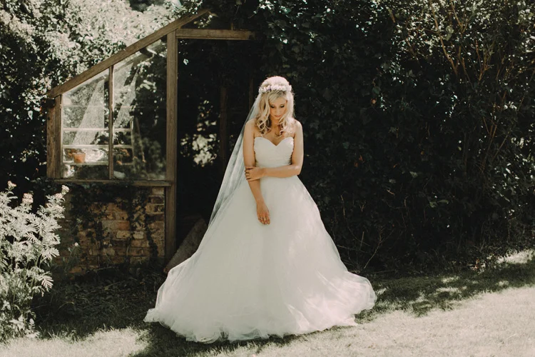 boho bride poses in her garden before chesham wedding