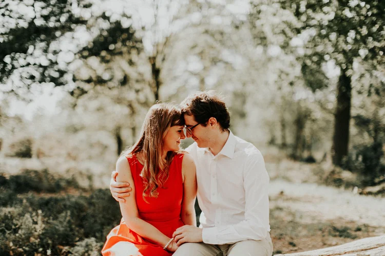 french and russian couple share intimate moment touching foreheads in london engagement