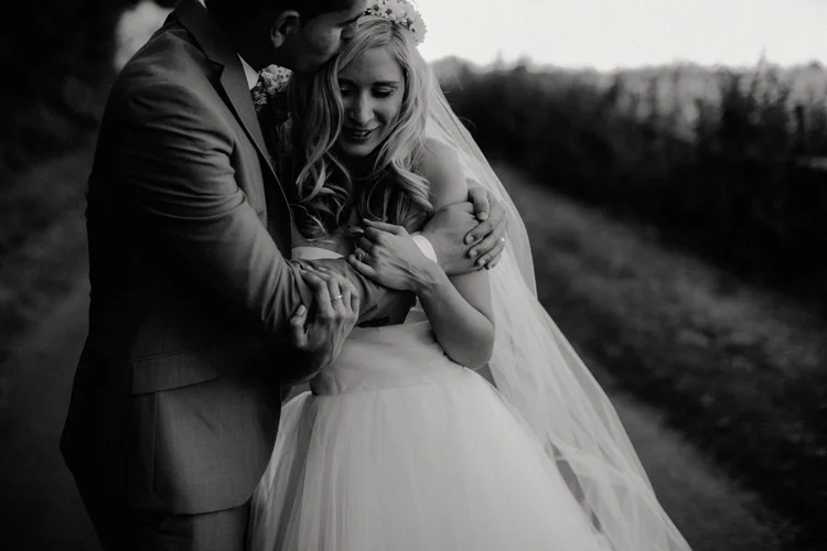 boho bride embraced by groom in chesham wedding