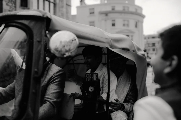 indian groom arrives to hindu ceremony in a tuk tuk