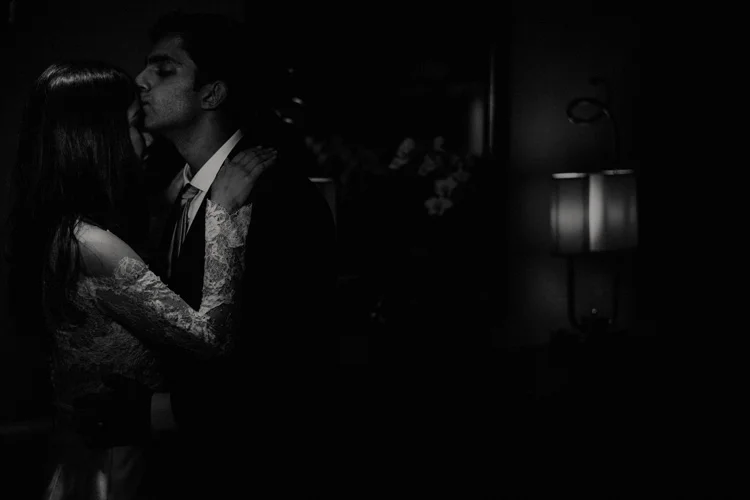indian groom kisses bride on forehead in london wedding