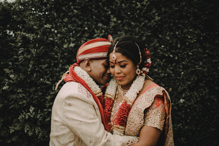 asian couple hold each other after hindu temple ceremony