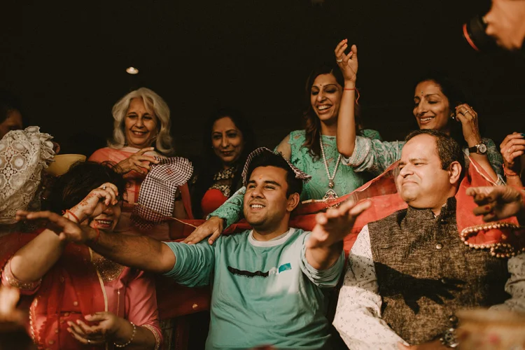 indian groom gets covered during puja