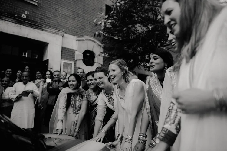 bridesmaids stop indian bride and groom from leaving hindu wedding ceremony