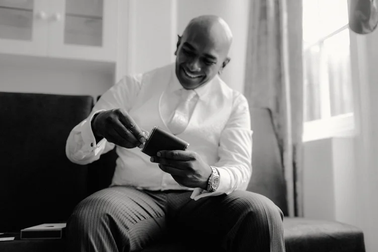 indian groom opens present from bride in london wedding