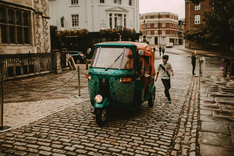 groom arrives to hindu ceremony in a tuk tuk