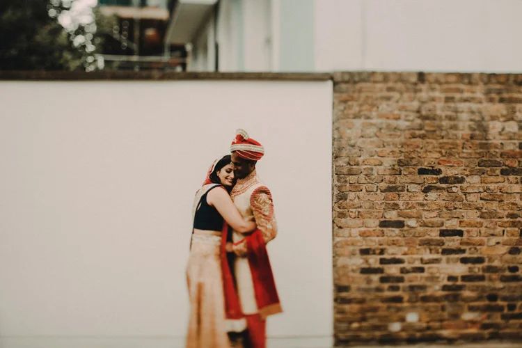 indian couple embrace in the streets of london after hindu ceremony