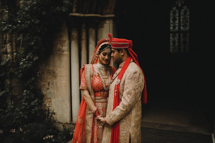 groom holds bride after traditional hindu ceremony