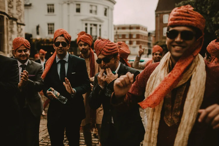 grooms family parade in southampton streets in hindu wedding recessional