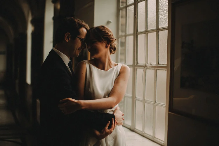 french groom holds russian bride in arms as couple share intimate moment in london islington wedding