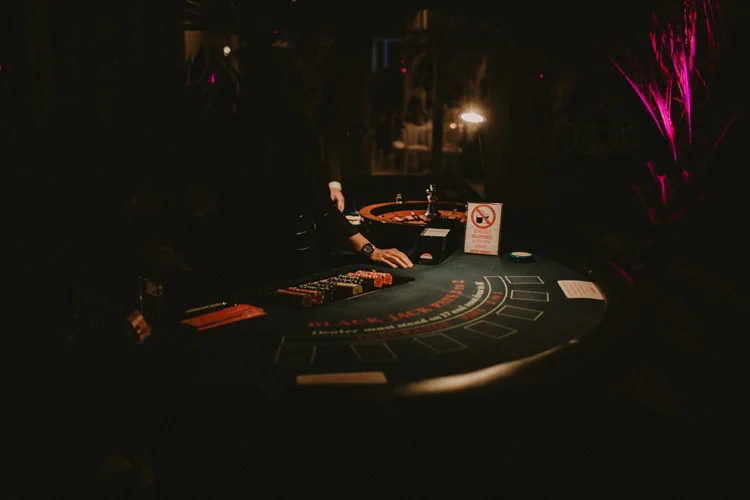 card dealer serves cards for poker game at syon park wedding