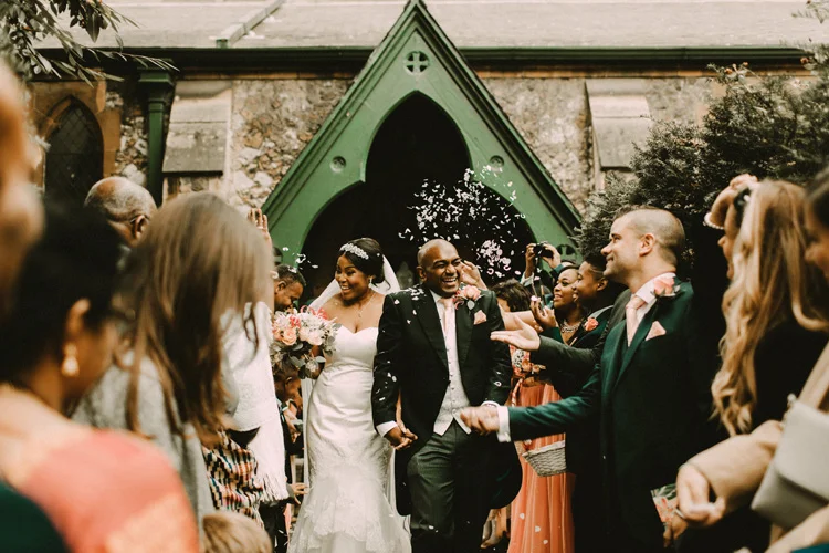 indian groom and african bride leave traditional london wedding 