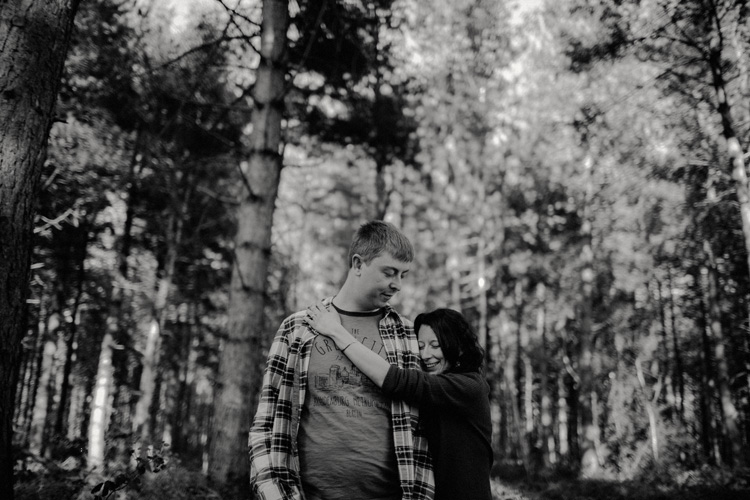 alice hugs sam in birchington forest engagement session