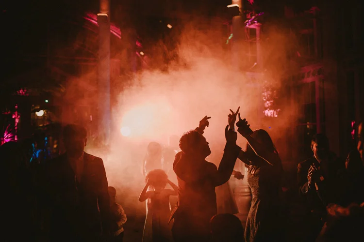 guest dance with smoke machine during syon park wedding reception