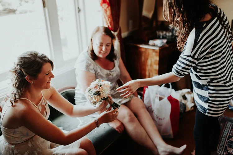 bride gives braidsmaid vintage bouquet in quex park wedding
