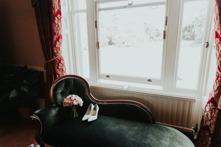 brides vintage bouquet and shoes at quex park wedding