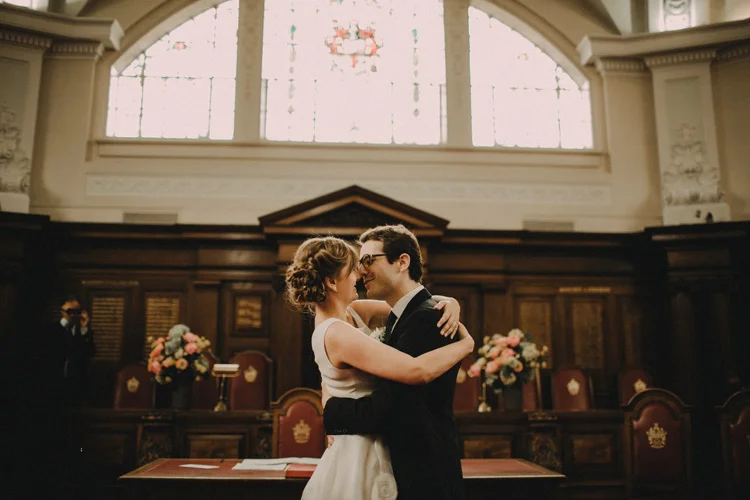 russian bride and french groom kiss during london civil wedding