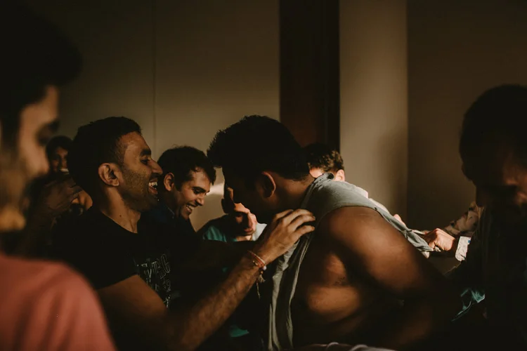groomsmen tear grooms clothes during ritual in hindu wedding