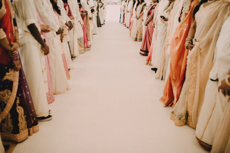 Family members queue to welcome groom to hindu wedding
