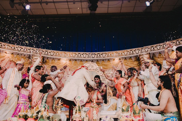 groom places Mangala sutra around brides neck in london hindu wedding 