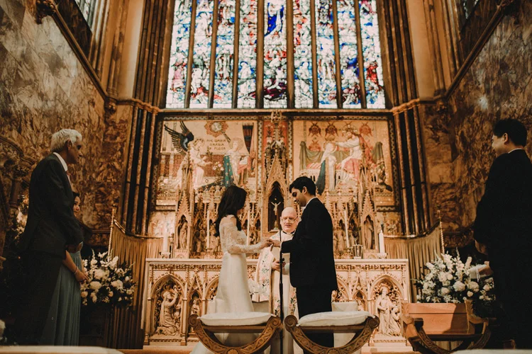 bride and groom at the altar in farm street church wedding