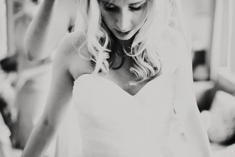 boho bride is laced into her wedding dress in chesham wedding