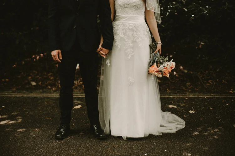 bride and groom hold hands in surrey wedding