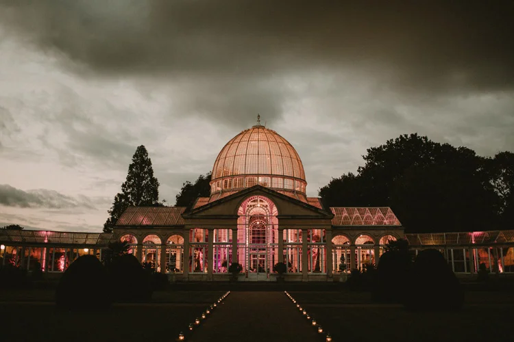 the Great Conservatory lit up in the evening in syon park wedding