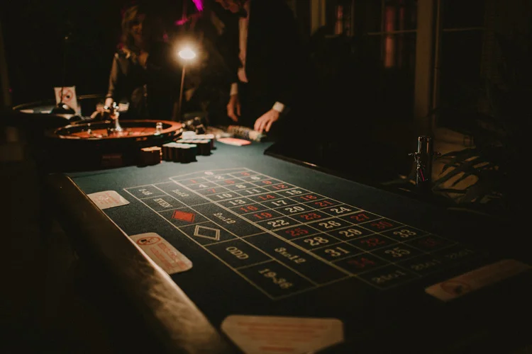 card dealer deals card during poker game in syon park wedding reception