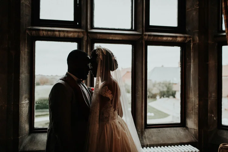 bride and groom share a kiss after froyle park wedding