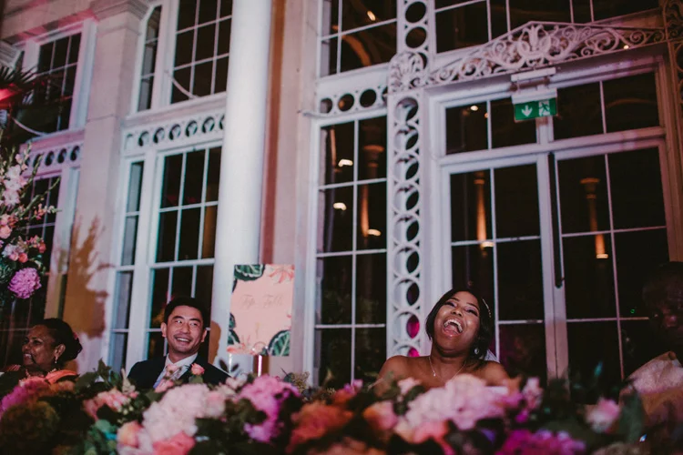 modern bride laughs during best man speech at syon park