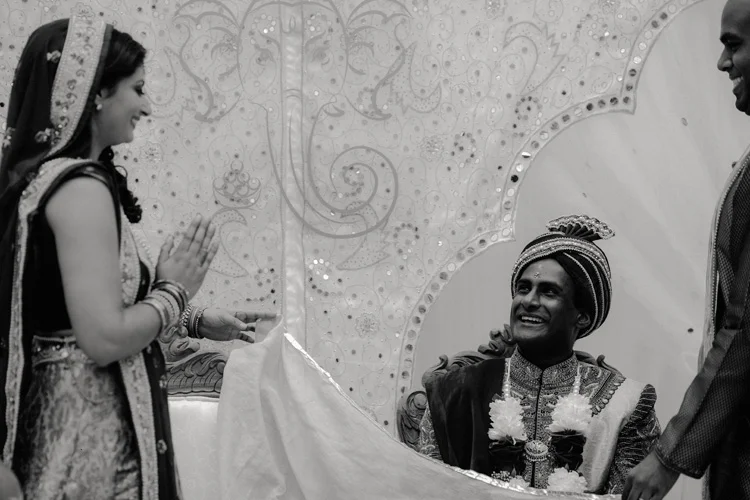 bride is unveiled to groom during hindu wedding ceremony