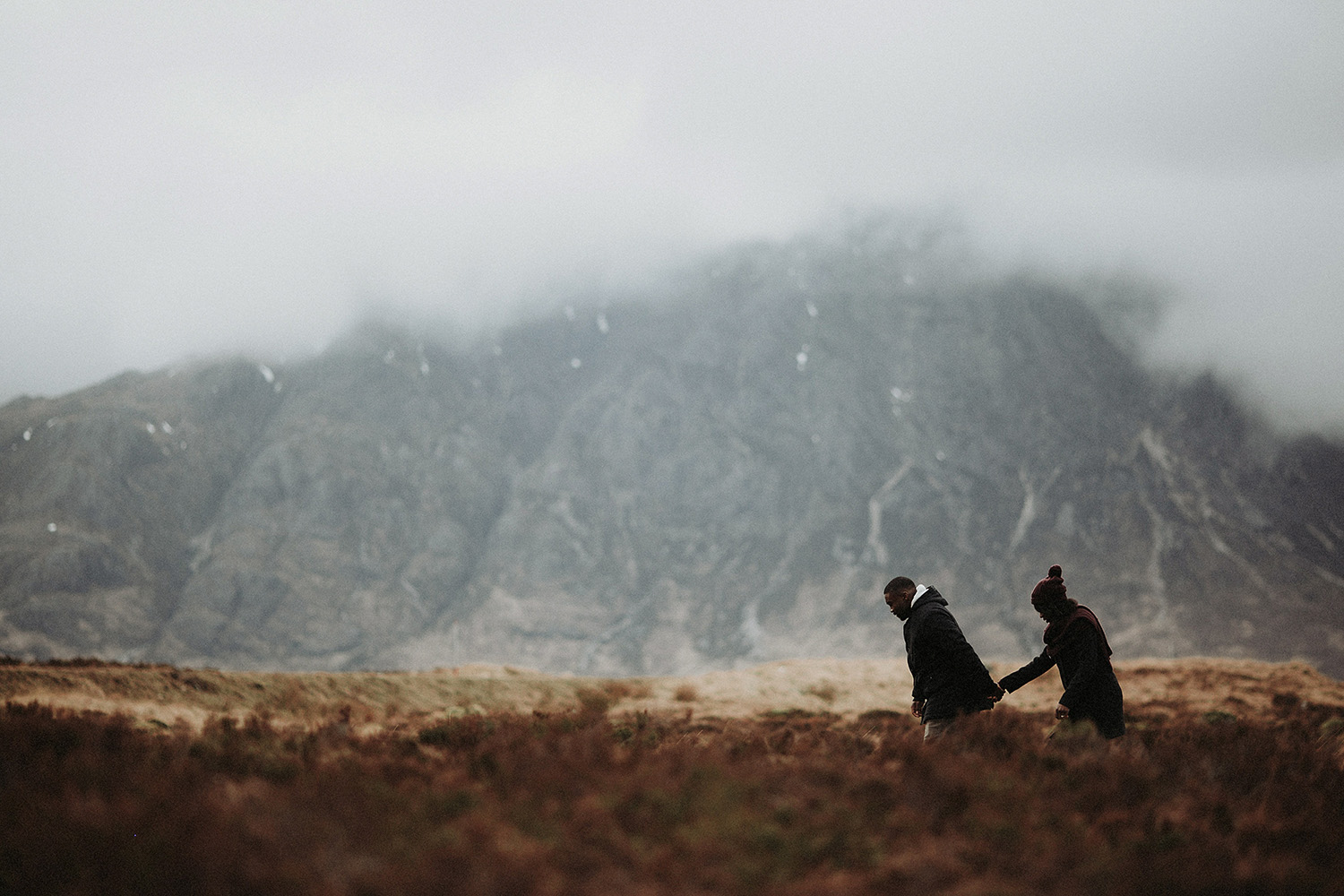 Copy of Copy of couple share intimate moment walking through glencoe mountain