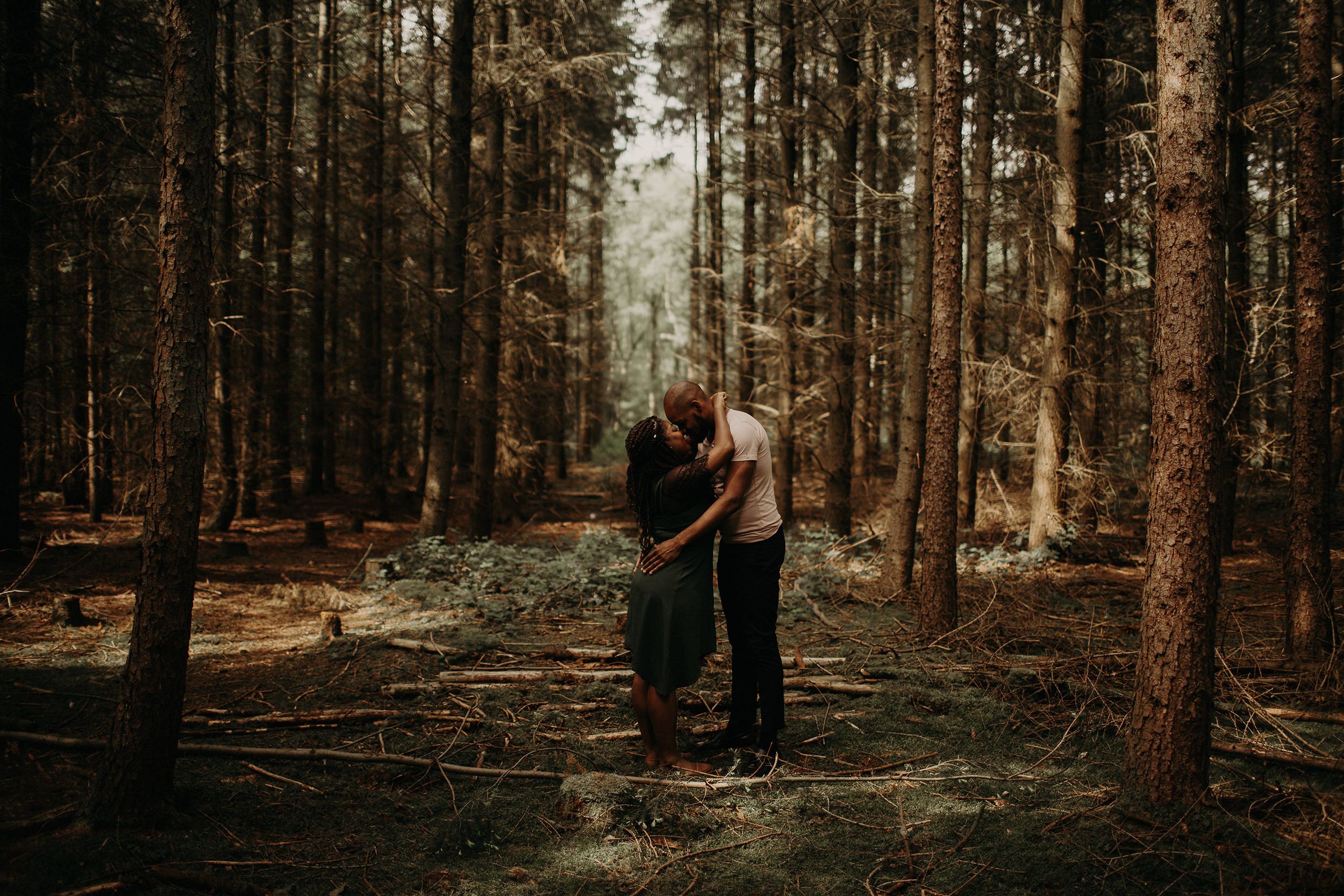 engaged couple sharing intimate moment in the Black Forest