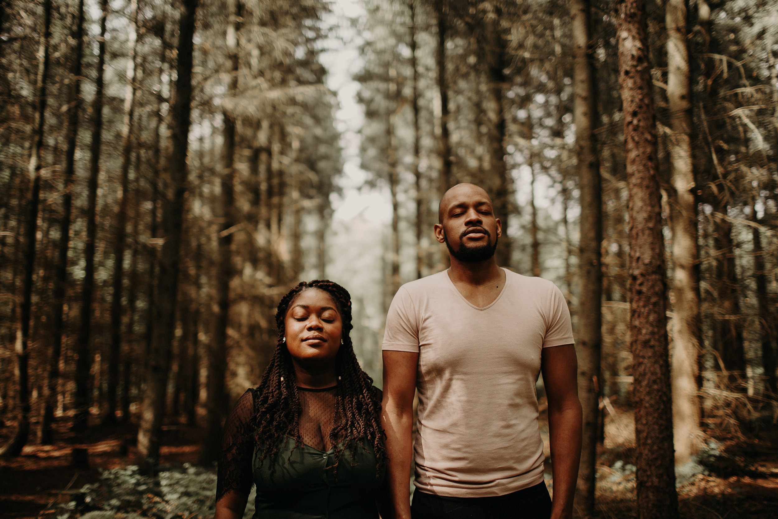 engaged couple holding hands in the black park