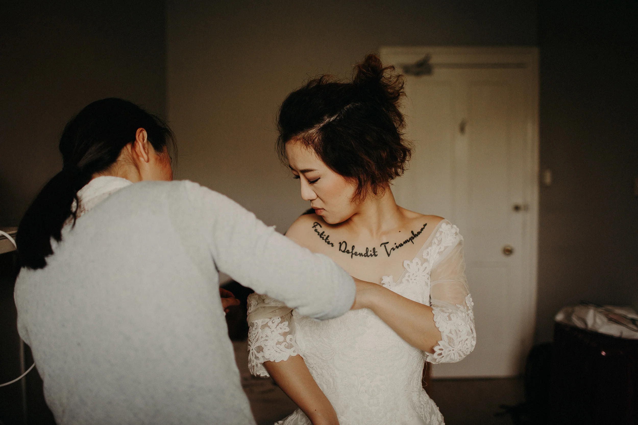 tattooed bride getting ready during edinburgh elopement