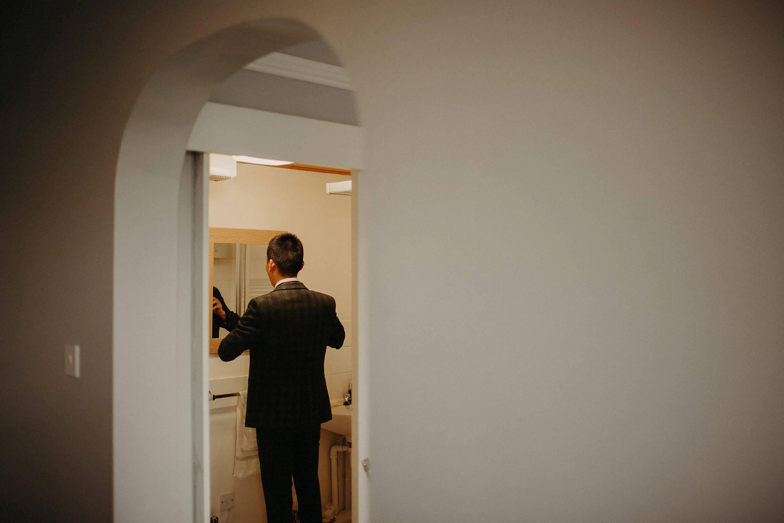 tattooed groom getting ready during edinburgh elopement