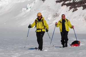 Brigitte Sabard and Olivier Gilg (with Vladimir in the sled) coming back from rocks were we found lichen and flowers.