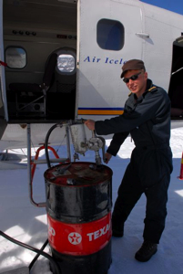 Arnar, one of the two pilots, refuels the plane from the drum they had left behind the day before.