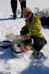 Brigitte quickly installs our kitchen as soon as the plane leaves, melting snow for many purposes.