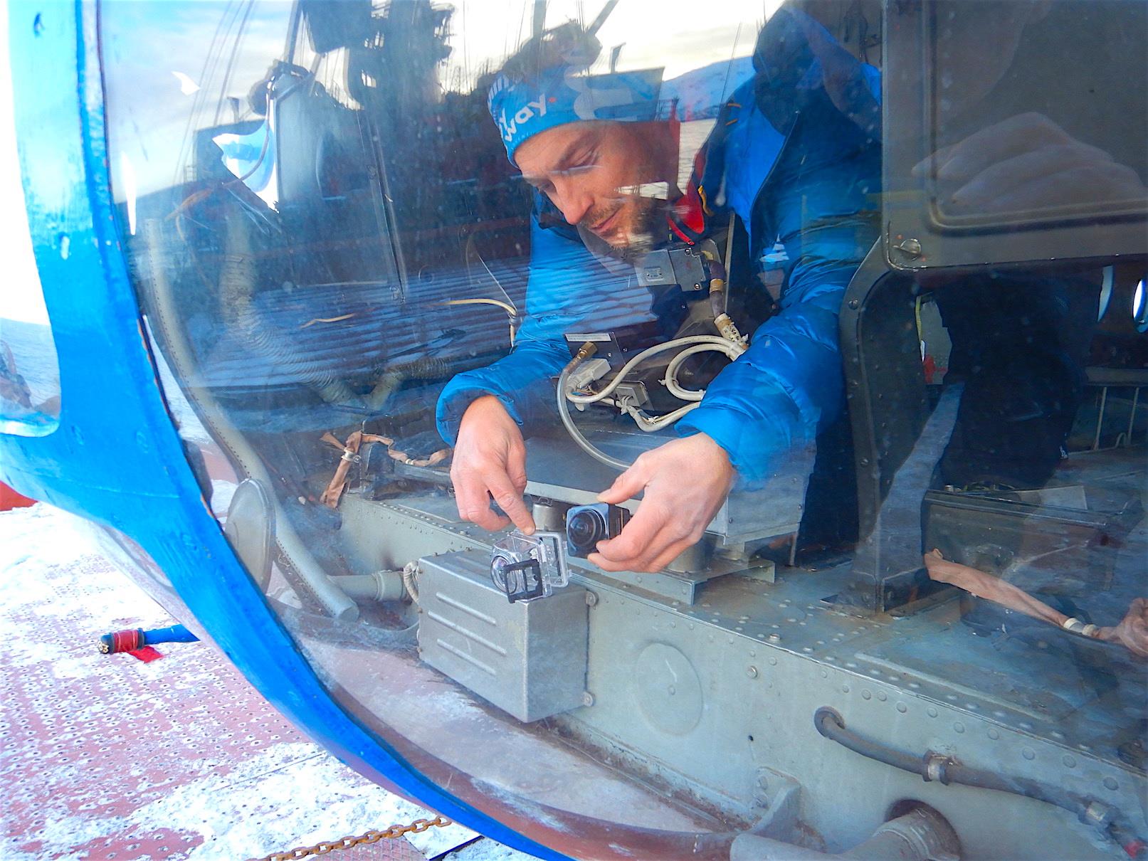 Setting up a Kodak fish-eye cam in the helicopter cockpit. The video imaging will be used to 3Dmodel the islands we will study