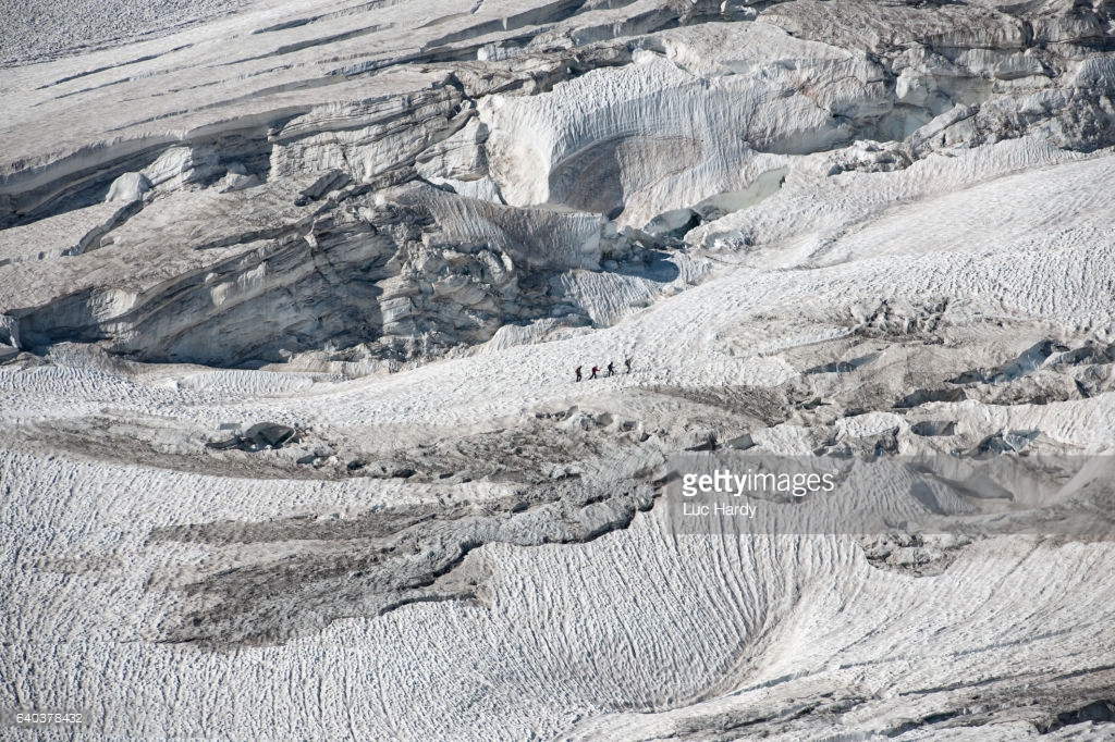 Alpinists walking in the distance.jpg