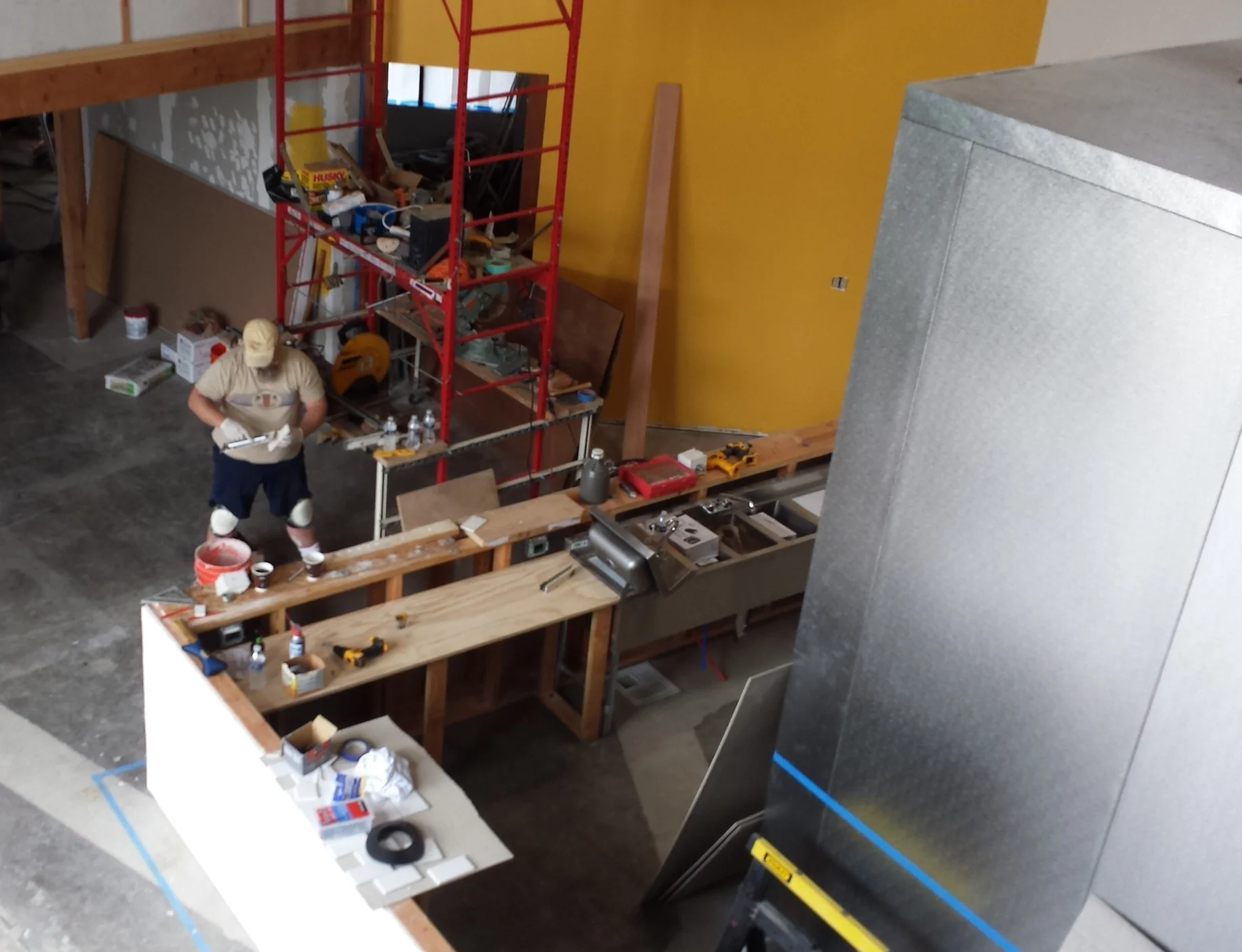 Scott tiling the bar facade. 