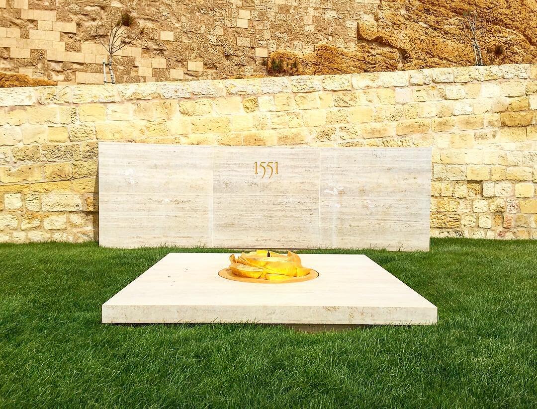 1551 monument at the entrance to the Citadel beautifully designed by John Grima // #Victoria #Gozo #Malta #Citadel #monument #sculpture #art #design #gold #minimalism #grass #stone