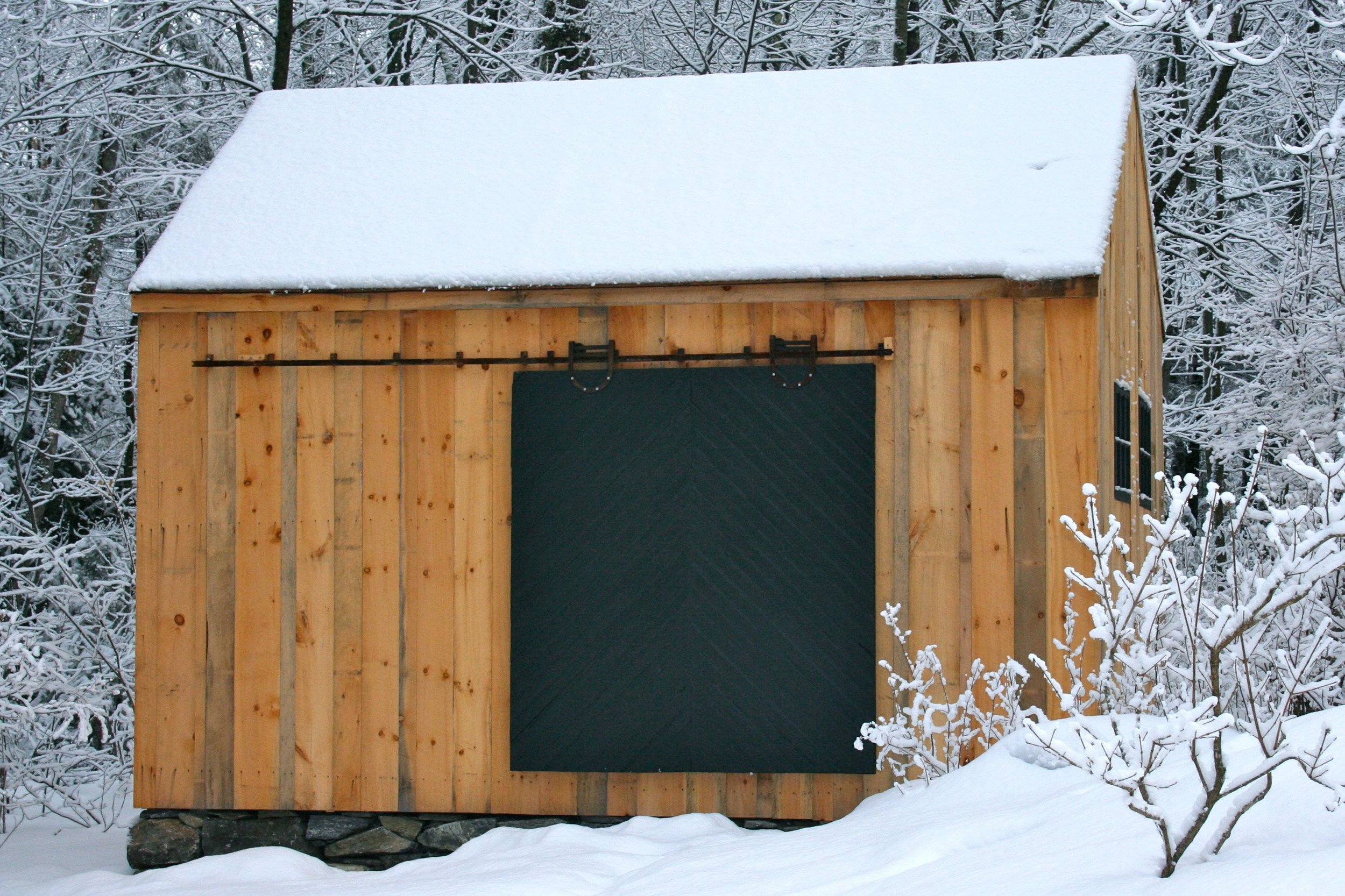 This barn's foundation was built from stones found on the property, and the reclaimed door and hardware are great finishing touches.