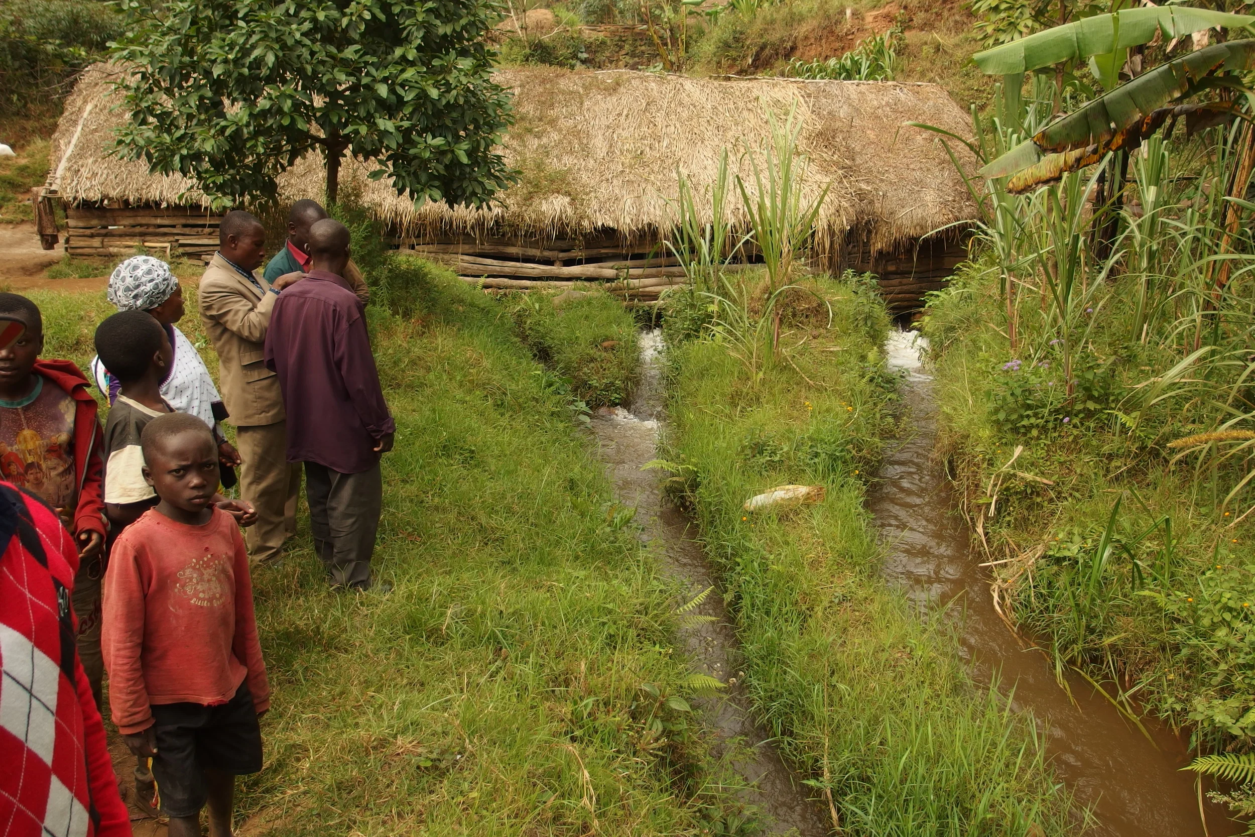 The dam structure that houses the turbines with members of the community use and take care of the dam.